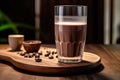 a tempting glass of rich chocolate milk, invitingly placed on a rustic wooden table. Royalty Free Stock Photo