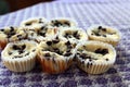 Mini-cheesecakes cooling on purple background