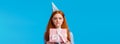 Tempting moment of unwrapping gift. Cute glamour redhead teenage girl biting lip eager open cute birthday present
