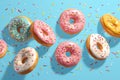 Tempting treats pink donuts adorned with sprinkles against blue backdrop