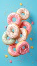 Tempting treats pink donuts adorned with sprinkles against blue backdrop