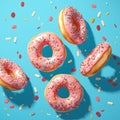 Tempting treats pink donuts adorned with sprinkles against blue backdrop