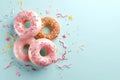 Tempting treats pink donuts adorned with sprinkles against blue backdrop