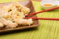 Tempura prawns with chopsticks on bamboo tablecloth