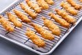 Tempura shrimp just cooked on a cooling rack