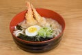 Tempura udon with fried shrimps, boiled egg, green algae, leeks, tipical japanese noodles