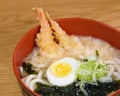 Tempura udon with fried shrimps, boiled egg, green algae, leeks, tipical japanese noodles