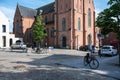 Temse, East Flemish Region, Belgium - Central square and church of the village with cars and a trekking bike