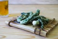 Temuras ofwild vegetable called Taranome on the raft shaped bamboo tableware Royalty Free Stock Photo