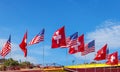 Ten american and swiss flags waving in row on blue sky background Royalty Free Stock Photo