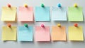 Ten colorful sticky notes with handwritten messages and grid patterns are pinned to a white board. Different colored pins secure Royalty Free Stock Photo