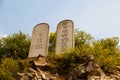 Ten Commandments List. Stone tablets on a rocky hill with carved