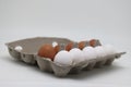 Ten eggs in a carton. A dozen raw white and brown eggs.