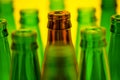 Ten empty beer bottles on a yellow background