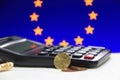 Ten Germany euro cent on obverse and two coin of two euro cent on white floor with black calculator and pencil, Euro flag. Royalty Free Stock Photo