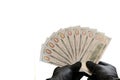 Ten hundred dollar bills and black rubber gloves. Thousand US dollars as a fan in male hands. Isolated on white background. Copy Royalty Free Stock Photo