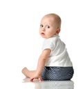 Ten month old infant baby boy toddler with blue eyes sitting backwards