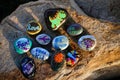 Ten painted rocks on a boulder Royalty Free Stock Photo