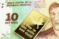 A ten peso banknote from Argentina with a gold bar in macro