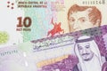 A peso note from Argentina, close up with a Saudi riyal bill