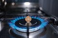 ten-ruble coin in a fire on the burner of the gas stove. the energy crisis.