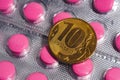 A ten russian ruble coin is placed on the package of tablets Royalty Free Stock Photo