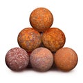 Ten rusty iron cannon balls on white background Royalty Free Stock Photo