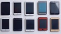 Ten tablets in various colors and designs arranged on a white surface Royalty Free Stock Photo