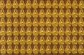Ten thousand golden buddhas lined up along the wall