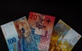 Ten, twenty and hundred swiss francs. swiss currency on black background Royalty Free Stock Photo