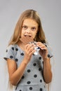 A ten-year-old girl eats a chocolate bar