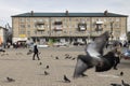 A ten-year-old girl runs along the central square against the background of a typical block four-story building from the Soviet