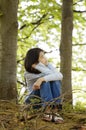 Ten year old girl sitting quietly in woods Royalty Free Stock Photo