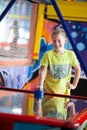 Ten years old happy and smiling boy playing air hockey on children games room