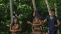 Group of young people dancing with typical costumes of the ethnic groups of the Ecuadorian Amazon in a park