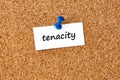 Tenacity. Word written on a piece of paper, cork board background Royalty Free Stock Photo