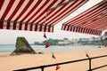 Tenby `Pembrokeshire iconic seaside destination golden sandy beach with bunting and the iconic Tenby colourful houses