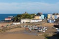 Tenby South Wales uk in summer with tourists and visitors and blue sky and boats in harbour