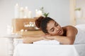 Tender african girl resting relaxing with closed eyes in spa salon. Royalty Free Stock Photo