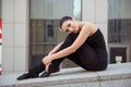 Tender attractive ballerina sitting on the balusters