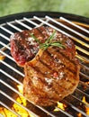 Tender beef steaks grilling over the flames Royalty Free Stock Photo