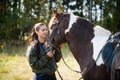 Tender communication between a rider and her horse before a riding lesson Royalty Free Stock Photo