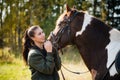 Tender communication between a rider and her horse before a riding lesson Royalty Free Stock Photo