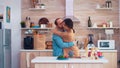 Tender couple dancing in kitchen