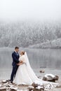 Tender couple in love. brides mountain near the lake in winter