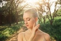 Tender dancer woman in green flowers landscape at sunset