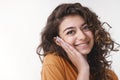 Tender delighted young flirty caucasian girl curly black hair pressing palm cheek blushing nice heartwarming compliment Royalty Free Stock Photo