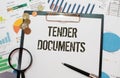 TENDER DOCUMENTS. text on an open notebook on an envelope with money. Royalty Free Stock Photo