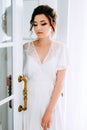 Tender elegant young bride with hairdo, hairpin and bridal makeup