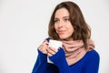 Tender happy woman in warm scarf drinking coffee from mug